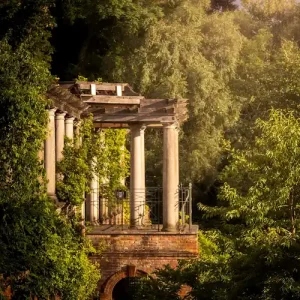 Elegant pergola surrounded by lush greenery in North London, a discreet and romantic setting for North London escorts meetings.