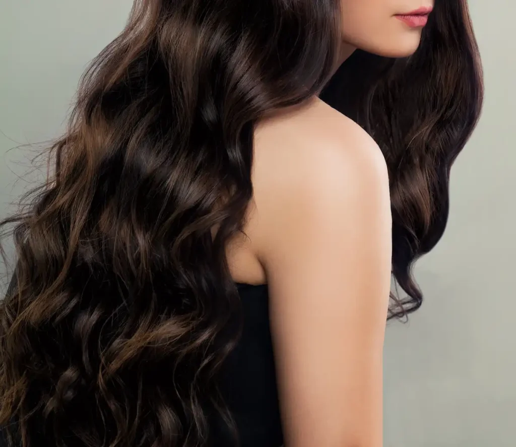 Elegant brunette middle eastern escort with long wavy hair and refined natural beauty.