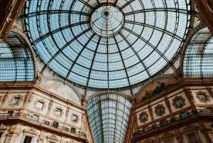 Glass dome inside Galleria Vittorio Emanuele II in Milan during a luxury city escape with a paid female travel companion